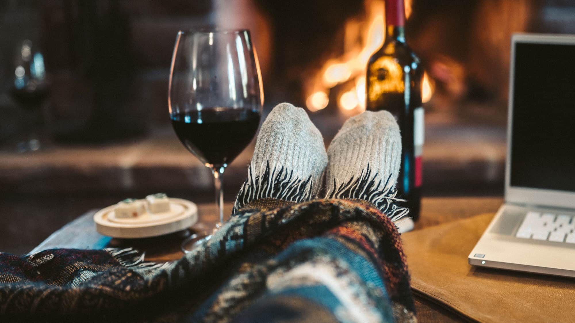 Feet up with Glass of Wine in front of fireplace